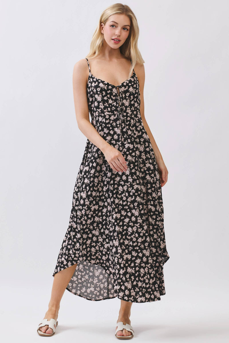 Woman wearing a black floral dress on a white background
