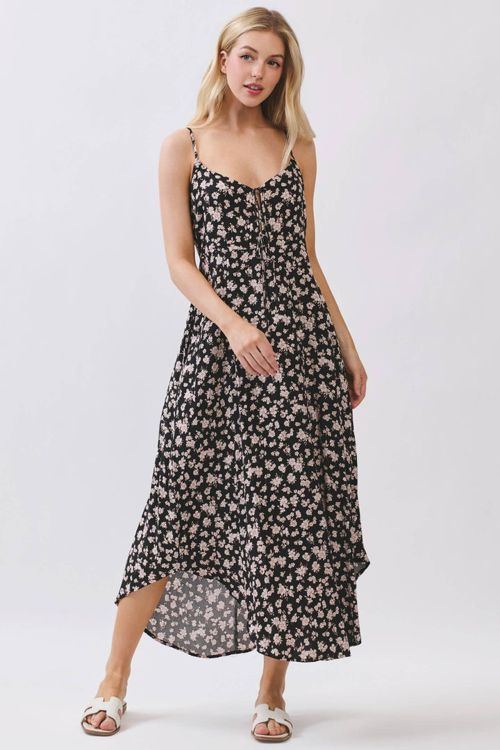 Woman wearing a black floral dress on a white background