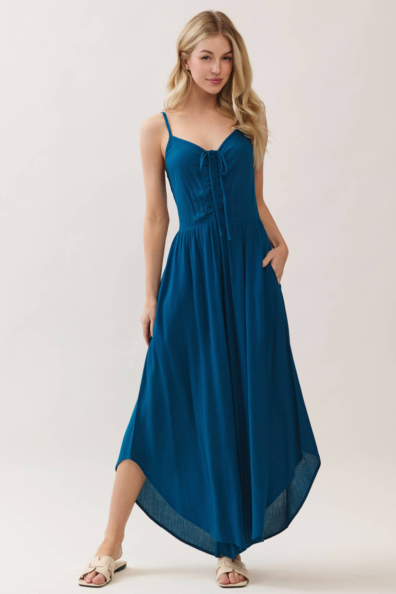 Woman wearing a blue jumpsuit on a white background
