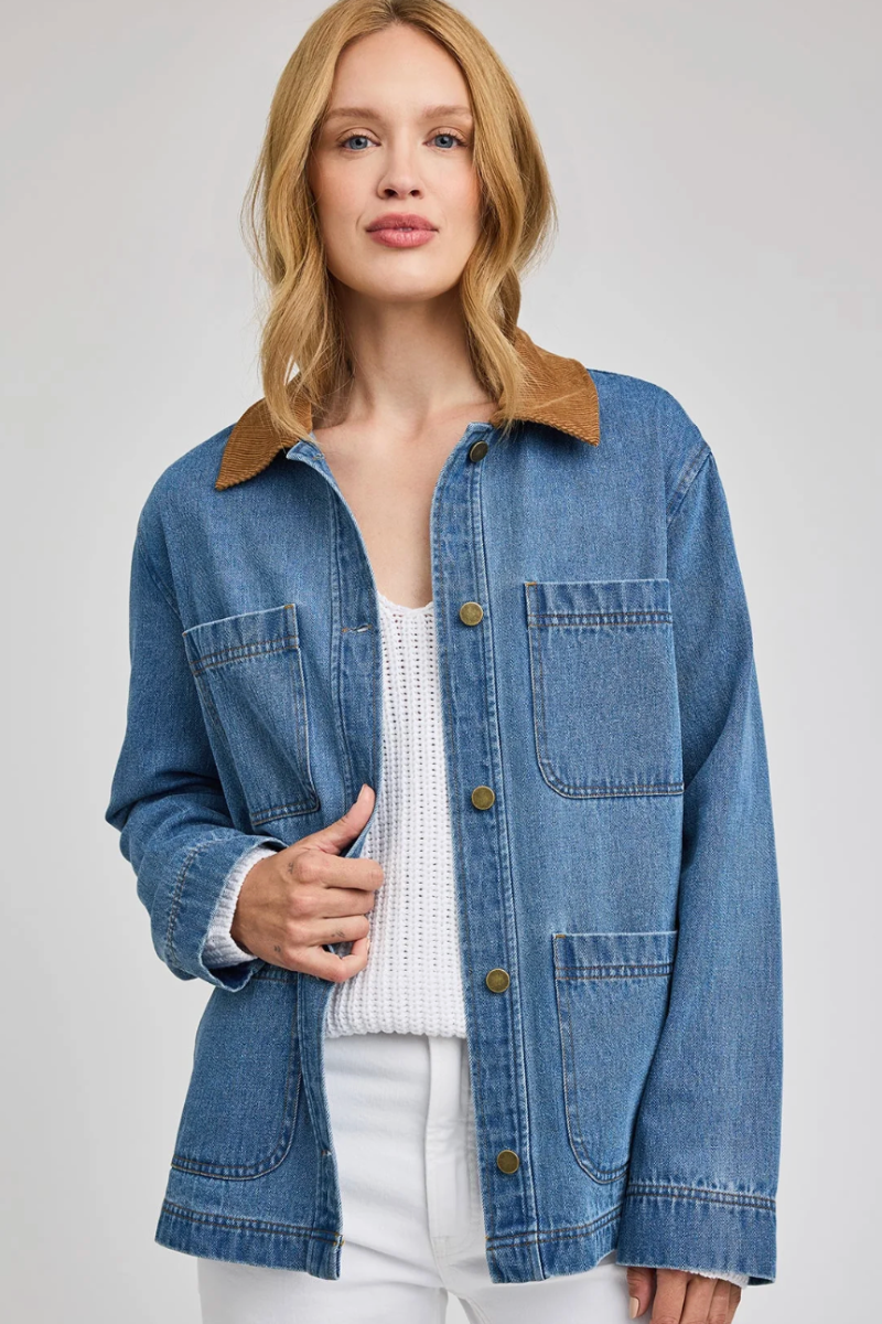 Woman wearing a blue denim jacket with a white background
