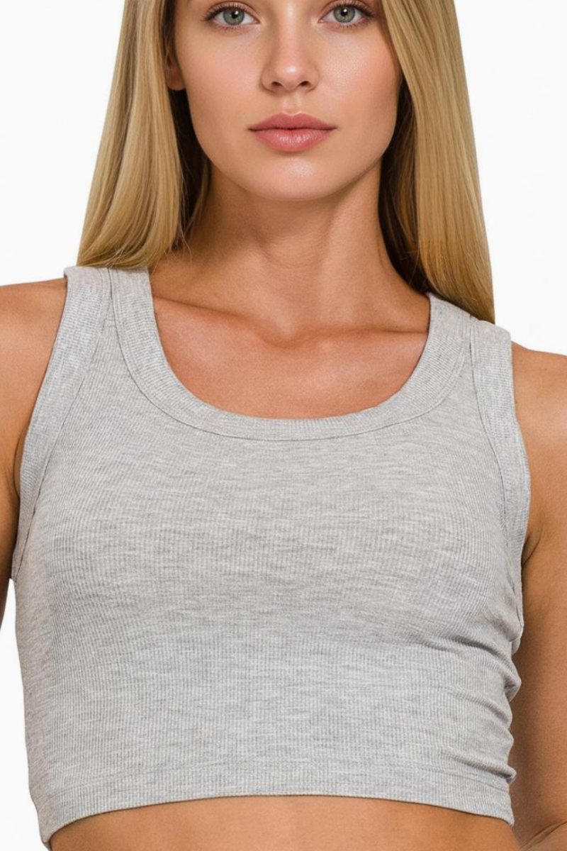 Woman wearing a gray tank top against a white background