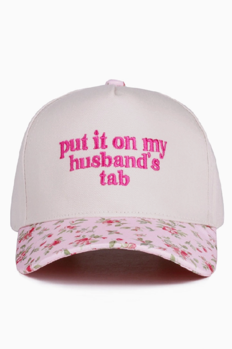 Cap with floral brim and text 'put it on my husband's tab' on a white background