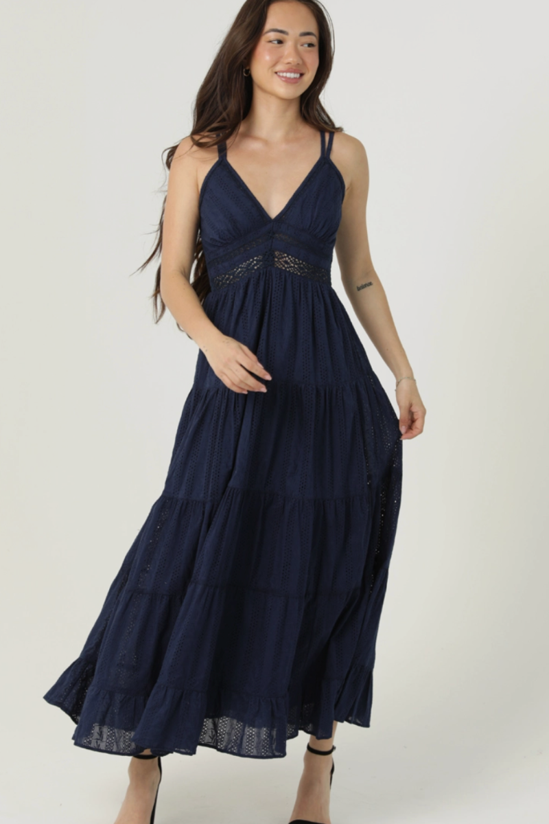 Woman wearing a navy blue dress against a white background