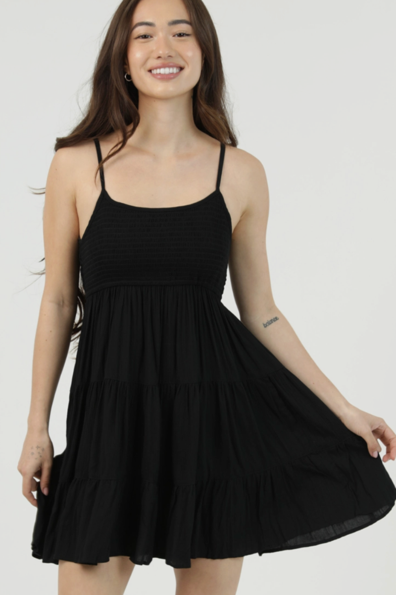 Woman wearing a black dress against a white background
