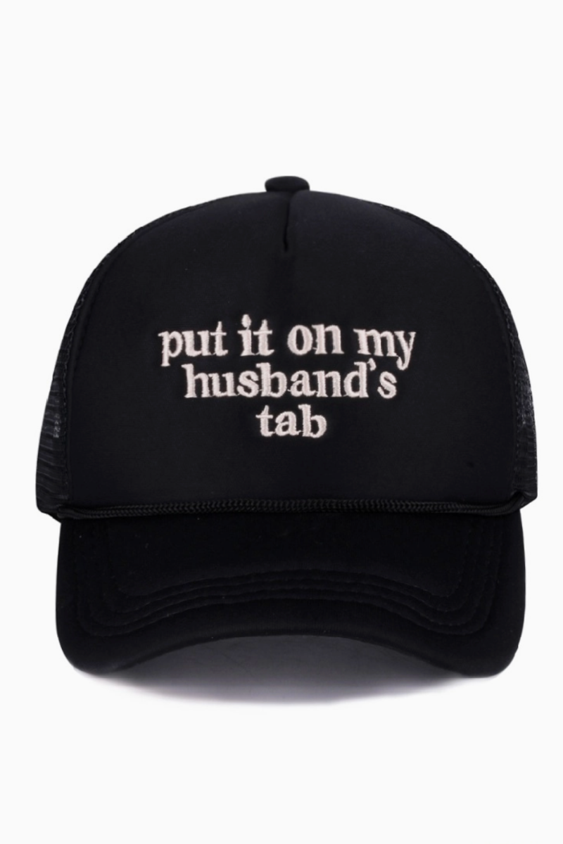 Black cap with white text 'put it on my husband's tab' on a white background