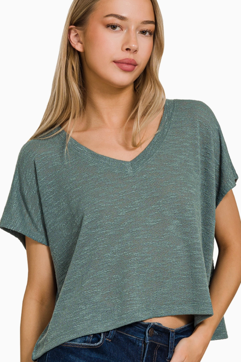 Woman wearing a green oversized t-shirt against a white background