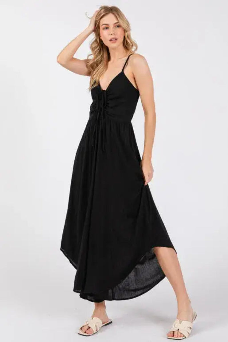 Woman wearing a black jumpsuit on a white background