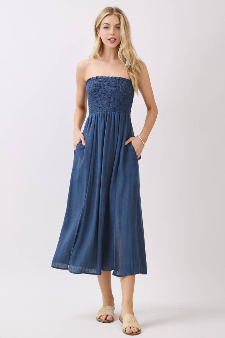 Woman wearing a strapless blue dress on a white background